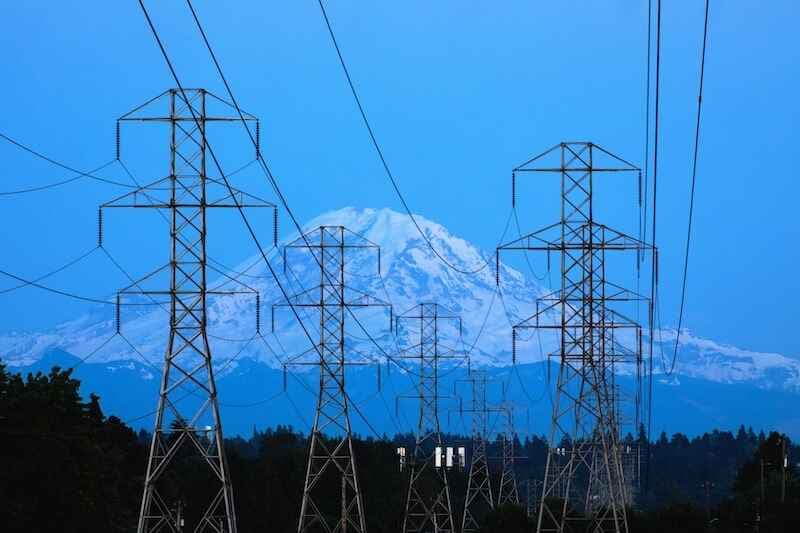 Electrical transmission lines run in the direction of Mount Rainier as they cut through the Beacon Hill neighborhood of Seattle, Wash